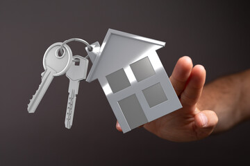 Image of a hand receiving house keys, perfect for real estate, homeownership, and property concepts.