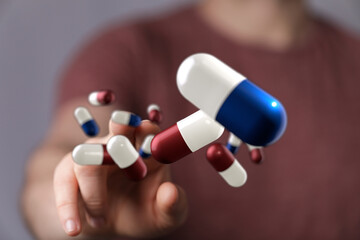 Image of a person interacting with digital capsules. Perfect for healthcare, medicine, and...