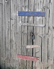 The padlock hangs on an old door