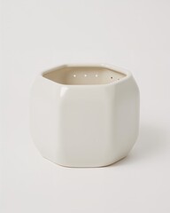 Octagonal glossy ceramic orchid pot with ventilation holes on plain white background