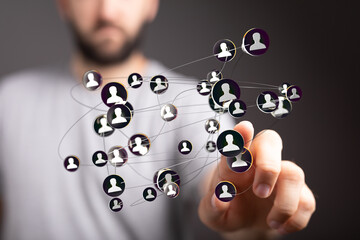 Image of a person interacting with a digital network of people, representing social media or...