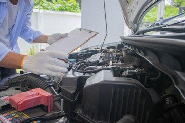 Technician in uniform inspecting car with clipboard, focusing on checklist, damage assessment, insurance claim, repair procedure, maintenance report, tools, transportation, expertise, service, 