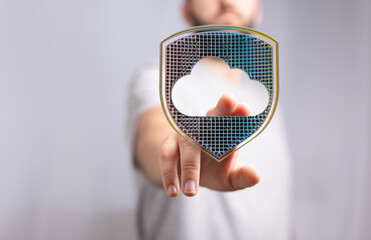 Image of a hand interacting with a digital shield protecting a cloud, symbolizing secure cloud...