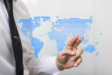 Businessman interacts with a digital world map, illustrating global network connections and...