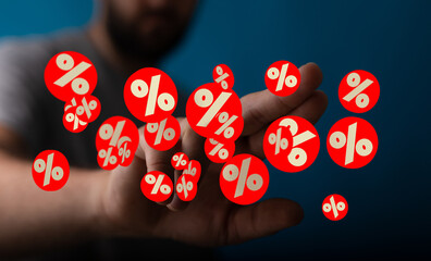 Image of a person holding multiple percentage symbols, ideal for sale, discount, and promotion...