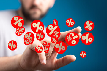 A man's hand displays numerous percentage symbols, illustrating discounts, sales, or interest rates.