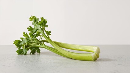 Stone slab with celery, emphasizing nutritious diets and the inclusion of vegetables in cooking.