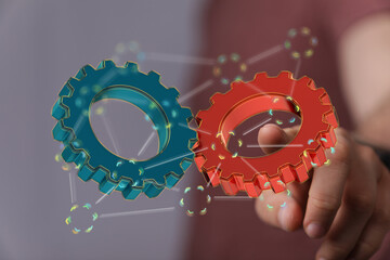 Abstract image of two gears working together, symbolizing teamwork, cooperation, and synergy.