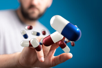 Abstract image of man interacting with digital pills, medicine, healthcare, technology