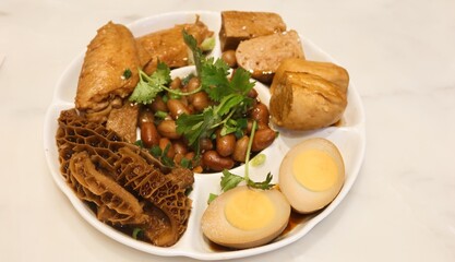 close up of Taiwanese soy marinated assort platter dish with boiled egg, tofu, beef stomach, peanuts and chicken wings with copy space on the right