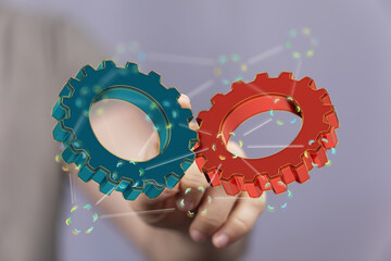 Image of two gears meshing, symbolizing teamwork, collaboration, and synergy.