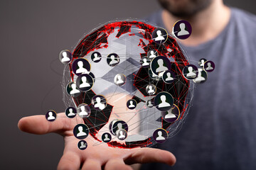 Hand holding a digital globe showing interconnected users.  Social media, networking, global...
