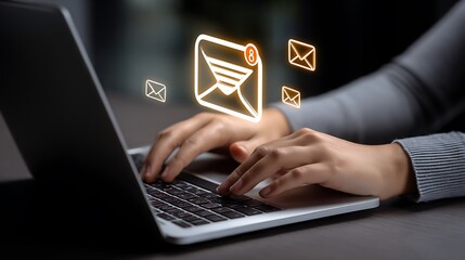 Person typing on a laptop with glowing email notifications appearing