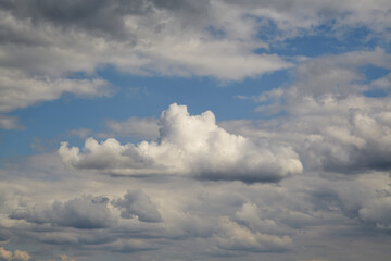 a white cloud among other clouds with texture. Suitable for art photography, posters, collages