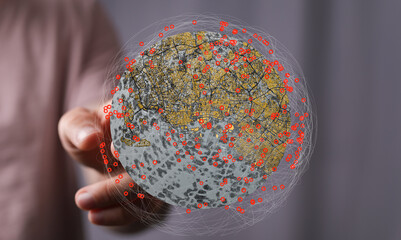 A hand interacts with a digital globe, showcasing interconnected data points and network visualization.