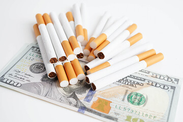 Cigarette on US dollar banknotes, cost, trading, marketing and production, No smoking concept.