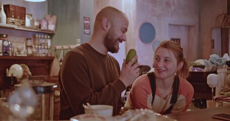 Friends enjoy a conversation and share a laugh in a cozy cafe. The warm atmosphere and friendly banter create a sense of connection and community.