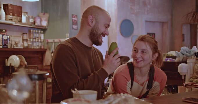Friends enjoy a conversation and share a laugh in a cozy cafe. The warm atmosphere and friendly banter create a sense of connection and community.