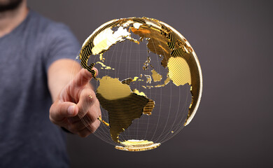 Hand interacting with a golden globe, representing global network, technology, and business.