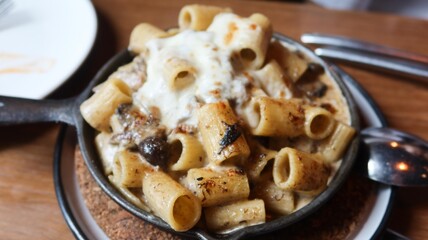 close up of Italain  baked black truffle cheese mushroom formaggi penne with copy space