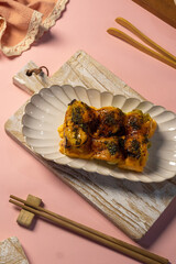 Top view of grilled dimsm mentai with melted cheese and nori on serving board. Ideal for Asian...