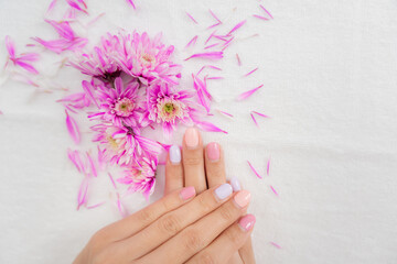 Woman show beautiful nail after receive care service by professional Beautician Manicure at spa...
