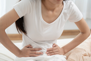 stomach ache. Asian women have abdominal pain, indigestion, gastritis, menstrual cramps,...