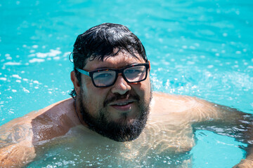 Costa rican man with glasses, diabetes, and high blood pressure is enjoying refreshing time in...