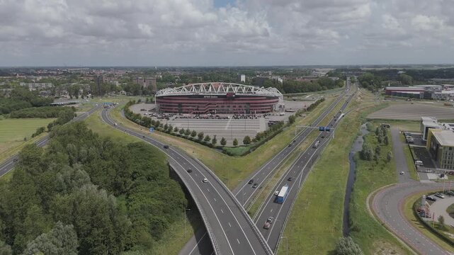 Alkmaar, Netherlands. 07-15-2025. Slow Aerial Rise Over AFAS Stadium and A9 Highway in Alkmaar, Netherlands