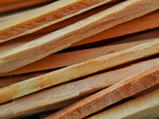 Closeup of stacked Palo Santo sticks aromatic wood texture natural incense.