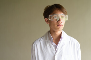 Young scientist student researcher wearing lab coat