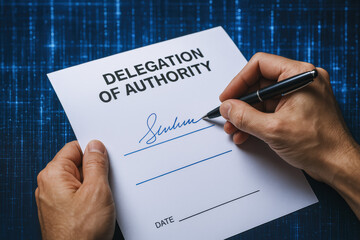 A formal agreement transfer is finalized as a signs a delegation authority document symbolizing responsibility and governance
