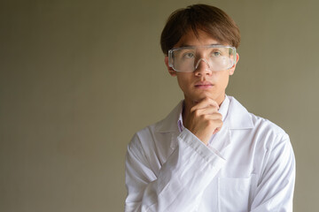 Young scientist student researcher wearing lab coat