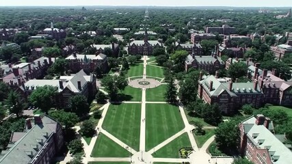 Aerial View of a University Campus with Green Lawn Brick Buildings and Trees Under Sunlight