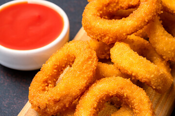 Fried onion rings on black background