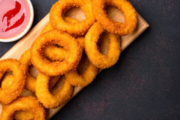 Fried onion rings on black background