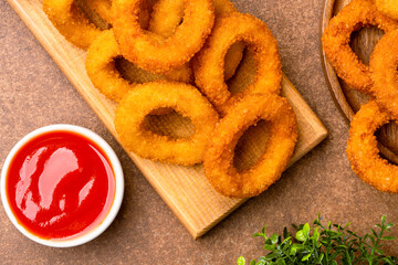 Fried onion rings on vintage brown  background