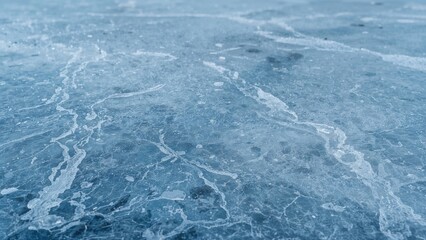 Macro shot of textured ice with skate marks on an outdoor frozen rink