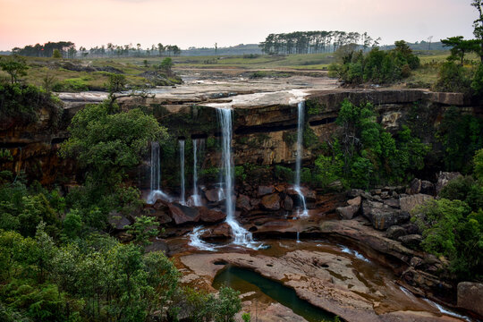 Majestic Phe Phe waterfall of Meghalaya, cascading over rocky cliffs,  surrounded by lush green foliage.