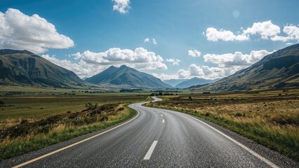 Naklejka premium Expansive view of a picturesque roadway winding through green terrain.