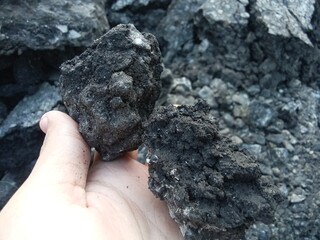 an illustration holding coal. mining theme	
