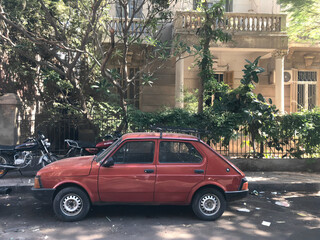 old car in front of a house