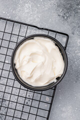 Healthy Fresh greek yogurt in a bowl. grey background. top view