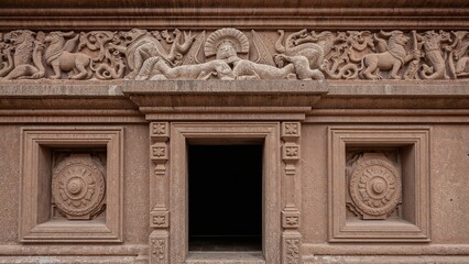 Obraz premium Intricate stone carvings on ancient architecture depicting mythical creatures and decorative motifs surrounding a dark entrance.