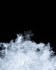 Macro snowflakes showing intricate winter details on dark background