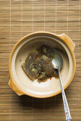 Overhead view of chicken stock in a bowl, top view of whole chicken stock