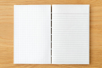 White grid and lined notebook mockup on a wooden table