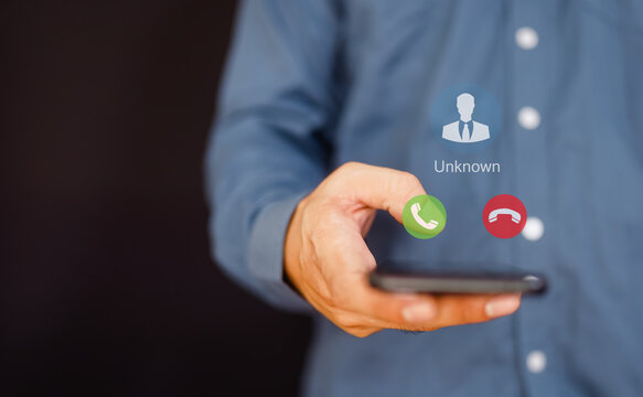 Unknown number calling in the middle of the night. Phone call from stranger. Man answering to incoming call. Phone call from unknown number. Call center gang, scammer or stranger.