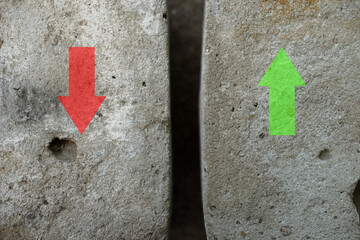 Red and green arrows on textured wall with symbols and numbers