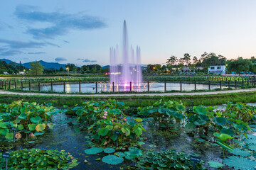 The view of the fountain in the park in summer, where cool streams of water are pouring in